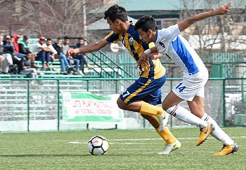 Real Kashmir Football Club's (RKFC) player Rohit Jhamat (L) plays with Delhi Dynamos Football Club Reserves (DDFCR) player Yagya Kapoor during the 2nd Division I-League in Srinagar on March 24, 2018. | AFP