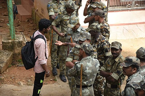 A security personnel inspecting the ID card of a media person at Pamba. (Photo | B P Deepu/EPS)