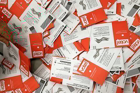 Election workers begin to sort a new batch of ballots collected earlier in the day from drop boxes at the King County Elections office Monday. (Photo| AP)