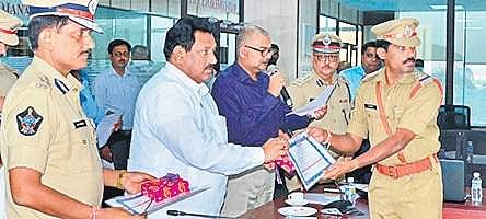 Deputy Chief Minister N Chinarajappa felicitating CI D Ramu on Monday
