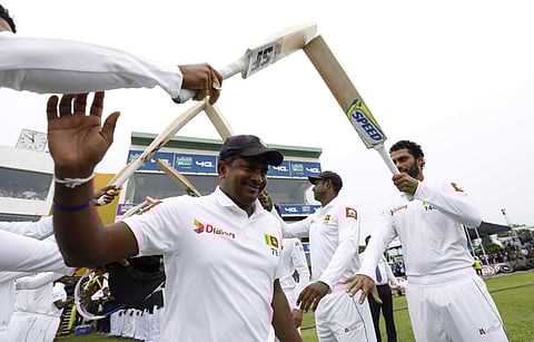 Sri Lanka's spin bowler Rangana Herath waves as he is greeted with an arch of bats while he enters the field for the last match of his test cricket career, the first test cricket match between Sri Lanka and England, in Galle. (Photo | AP)