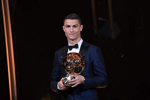 Portugese player Cristiano Ronaldo posing with the Ballon d'Or award in Paris. (File | AFP)