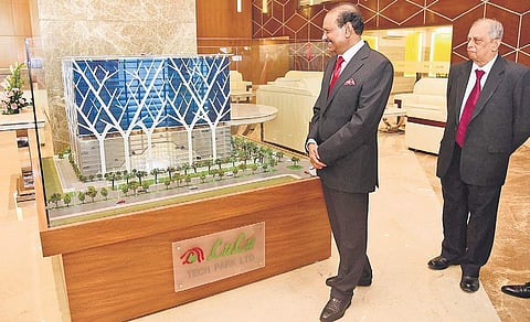 Yusuffali M A, CMD, Lulu Group, and A J Pai, Director, Lulu Tech Park, looking at a scale model of Lulu Cyber Tower-2 | Albin Mathew