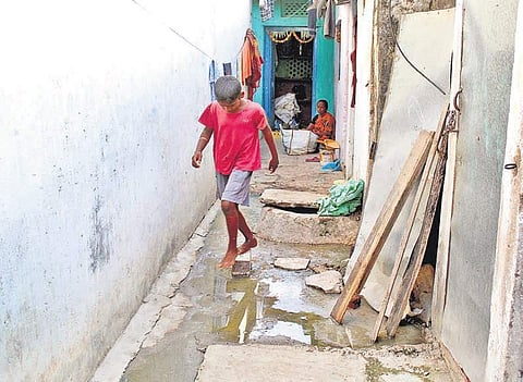Sewage water flows in front of a house in a slum at Khairatabad in Hyderabad on Friday | Sathya Keerthi