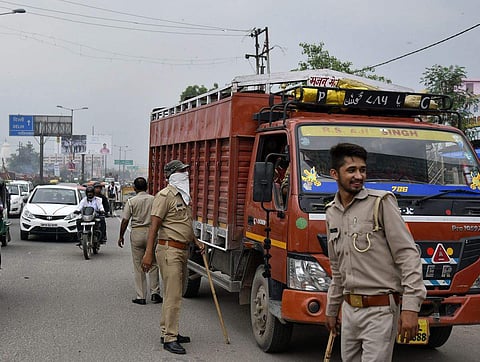 Police officers check commercial vehicles for customs purposes (Photo |  Anindito Mukherjee/Bloomberg)