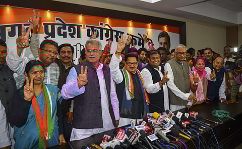 Congress in-charge of Chhattisgarh PL Punia flanked by party leaders display victory sign at a press conference after the party's win in the Assembly elections in Raipur Tuesday Dec 11 2018. | PTI