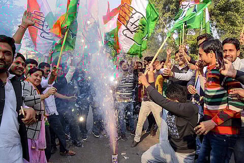 Congress party workers burst fire-crackers to celebrate the party's good show in Assembly elections of Rajasthan Chhattisgarh and Madhya Pradesh in Ahmedabad Tuesday December 11 2018. | PTI