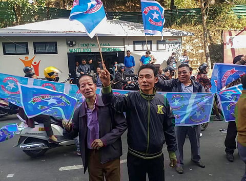 Mizo National Front MNF workers hold their party flag as they celebrate the party's victory in the states Assembly elections at Party head office in Aizawl Tuesday Dec. 11 2018. | PTI