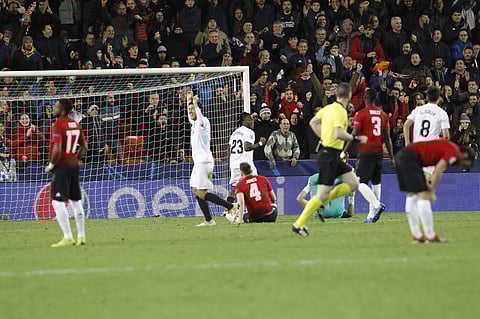 Valencia players celebrate after Manchester United's Phil Jones, center, scores an own goal (Photo | AP)