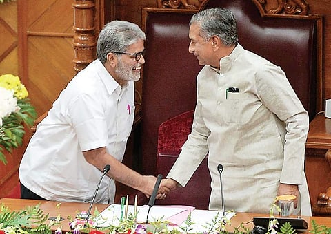 Pratap Chandra Shetty, new chairman of the Council, shakes hands with pro-tem chairman Basavaraj Horatti before taking charge at state council on Wednesday