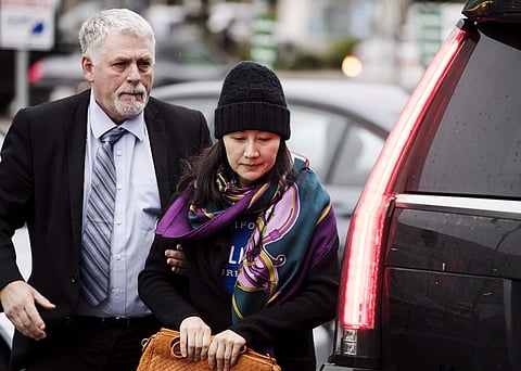 Huawei chief financial officer Meng Wanzhou arrives at a parole office with a security guard in Vancouver, British Columbia, Wednesday, Dec. 12, 2018.  | AP