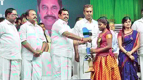 Chief minister Edappadi K Palaniswami distributes welfare assistance to beneficiaries as municipal administration minister S P Velumani looks on