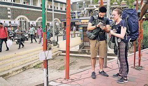 Foreigners wait outside the Central Railway Station Nandhakumar H V