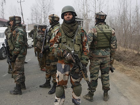 Indian soldiers stand guard near the site of a gun-battle in Mujagund area some 25 Kilometers (16 miles) from Srinagar, Indian controlled Kashmir, Sunday, Dec. 9, 2018. | AP