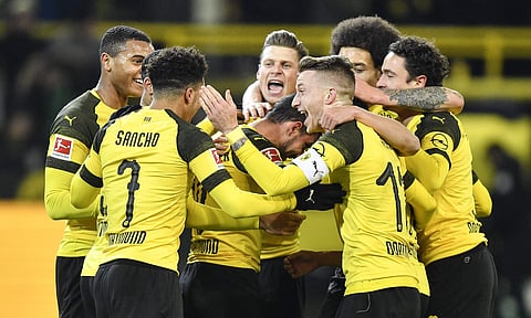 Borussia Dortmund's captain Marco Reus celebrates with his team the opening goal by Paco Alcacer (C) during the German Bundesliga match against Werder Bremen (Photo | AP)