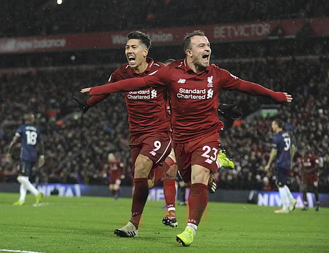 Liverpool's Xherdan Shaqiri, right, celebrates after scoring his side's third goal during the English Premier League soccer match between Liverpool and Manchester United. (Photo | AP)