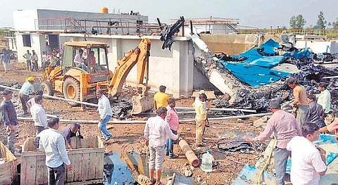 Men and machines clearing the debris after the blast at the factory. | Express Photo Services