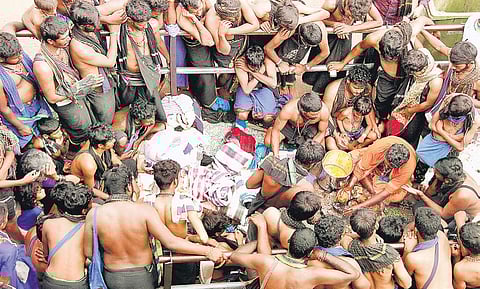 Pilgrims preparing for the Neyyabhishekam offering at Lord Ayyappa temple in Sabarimala on Sunday | SHAJI VETTIPURAM