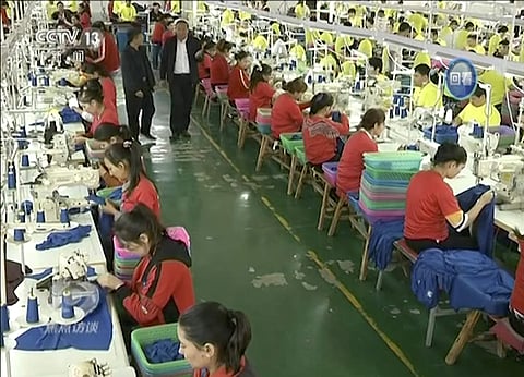 Muslim trainees work in a garment factory at the Hotan Vocational Education and Training Center in Hotan, Xinjiang, northwest China.  (FIle| AP Video via CCTV)