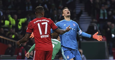 Bayern Munich goalkeeper Manuel Neuer reacts besides team mate Jerome Boateng after Bremen's Yuya Osako scored his side's opening goal during the German Bundesliga match  in Bremen, Germany | AP