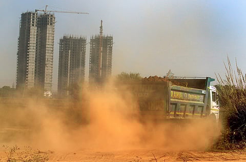 Dust flies as a truck moves past a construction site in Gurugram Saturday December 1, 2018. | PTI