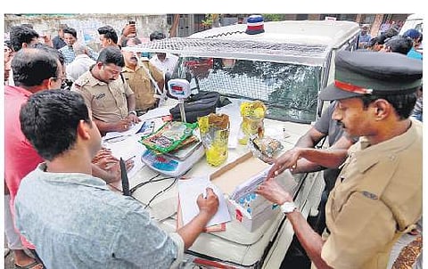 Police officers recovering methamphetamine and hashish oil