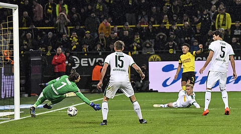 Borussia Dortmund's Jadon Sancho scores the opening goal against Moenchengladbach goalkeeper Yann Sommer during the German Bundesliga match (Photo | AP)
