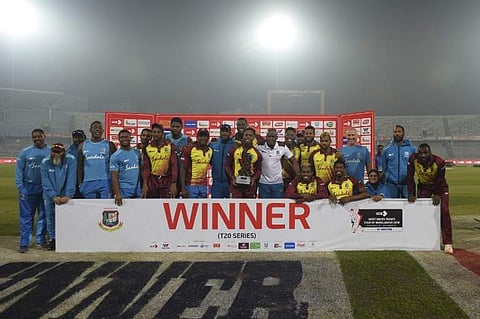 West Indies cricketers pose with the tournament trophy following the third Twenty20 (T20) cricket match between Bangladesh and West Indies at the Sher-e-Bangla National Cricket Stadium in Dhaka. (Photo | AFP)