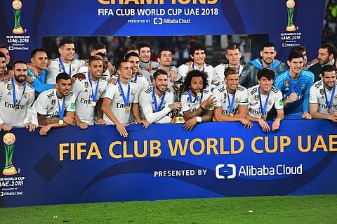 Real Madrid's players celebrate with the trophy after winning the FIFA Club World Cup final football match Spain's Real Madrid vs Abu Dhabi's Al Ain at the Zayed Sports City Stadium in Abu Dhabi. (Photo | AFP)