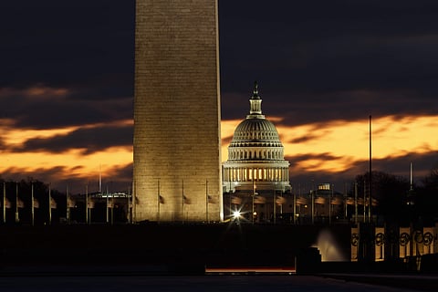The US Capitol dome is seen past the base of the Washington Monument just before sunrise in Washington (Photo | AP)