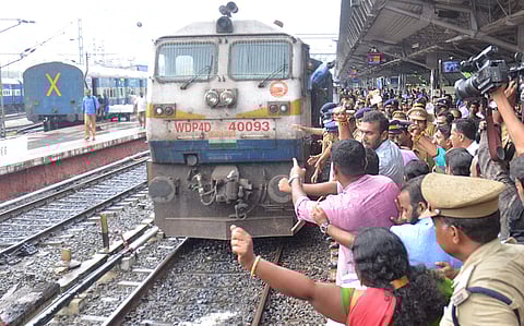 BJP activists protesting in front of a train which has three Manithi activists returning home (Photo | BP Deepu /EPS)