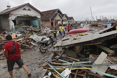 People inspect the damage at a tsunami-ravaged village in Sumur, Indonesia, Tuesday, Dec. 25, 2018. (Photo | AP)