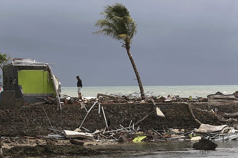 A man stands on the debris following a tsunami in Carita beach, Indonesia, Monday, Dec. 24, 2018. (Photo | AP)
