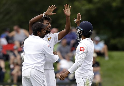 Sri Lanka's Suranga Lakmal, centre, is congratulated by teammates after taking the wicket of New Zealand's Neil Wagner. (Photo | AP)