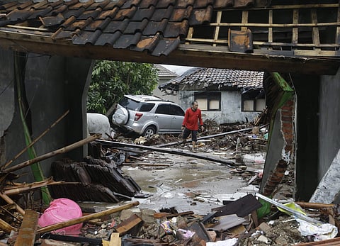 Volunteers clean the debris on the street following the tsunami in Carita, Indonesia, Wednesday, Dec. 26, 2018. (Photo | AP)