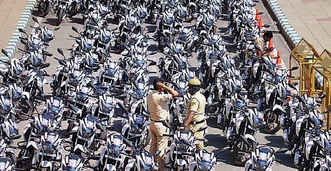 Police personnel wait for the Chief Minister to flag off 911 police patrol bikes  at Vidhna Soudha on Wednesday | Pushkar V
