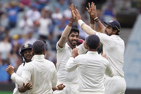 India's Jasprit Bumrah, center, celebrates with teammates after getting the wicket of Australia's Aaron Finch during play on day four of the third cricket test between India and Australia in Melbourne. (Photo | AP)