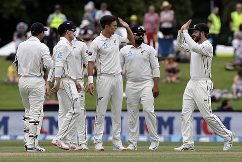 New Zealand's Kane Williamson, right, congratulates bowler Trent Boult after the dismissal Sri Lanka's Dushmantha Chameera of during play on the final day of the second cricket test between New Zealand and Sri Lanka at Hagley Oval in Christchurch. (Photo 