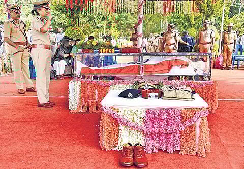 A police official pays respects to IPS officer Madhukar Shetty. His body was kept at Yelahanka Armed Police Training School in Bengaluru on Saturday | Nagaraja Gadekal