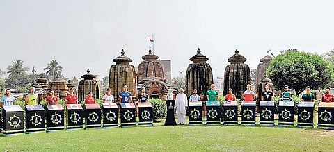 Odisha CM Naveen Patnaik with captains of 16 participating hockey teams and World Cup trophy on Mukteswar temple premises. (File | EPS)