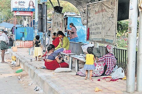 Homeless persons taking shelter at a bus stop in Hyderabad | S Senbagapandiyan