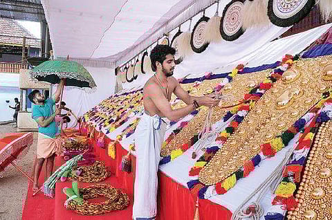 Temple authorities giving final touches to 'aanachamayam’ ahead of the Vrischikolsavam at  Sree Poornathrayeesa Temple. (Below) Shops set up ahead of the festival  A Sanesh