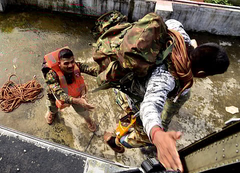 An Indian Army Personnel jumps off a naval chopper to help the flood victims in Kerala. (File photo | EPS)