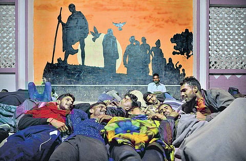 Territorial Army aspirants sleeping outside Cantonment Railway Station, and on a footpath in Benson Town on Monday night | Pushkar V