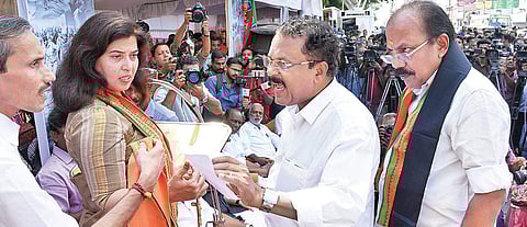 BJP state president P S Sreedharan Pillai and state general secretary M T Ramesh holding a discussion over who should translate BJP national general secretary Saroj Pandey MP’s speech during the inauguration of the relay hunger strike by state general sec