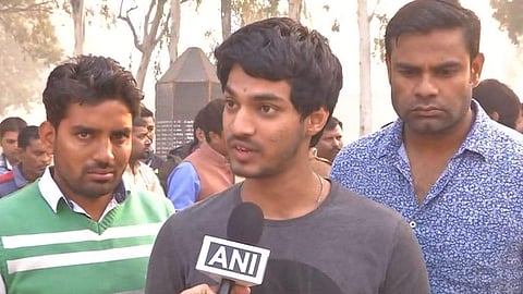 Abhishek, son of deceased policeman Subodh Kumar Singh. (Photo | Twitter/ANI)