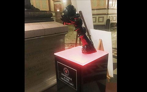 The Illinois state government has defended its decision to allow the exhibition of the controversial statue in the midst of Christmas decorations. (Photo|AP)