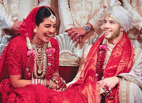 Global icons Priyanka Chopra and Nick Jonas got married on December 1 and 2. The couple followed Western and Indian traditions for the wedding. In this new photo from their Hindu wedding at Jodhpur's majestic Umaid Bhawan Palace, they look radiantly happy. (Photo | Instagram)