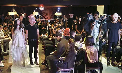 Cheyenne Jacobs, second from right, speaks as she stands next to a male model costumed as a pig during the #MeToo fashion show during Fashion Week in New York. (Photo | AP)
