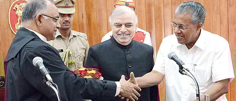 Chief Minister Pinarayi Vijayan greets new HC Chief Justice Antony Dominic as Governor P Sathasivam looks on in T’Puram | kaviyoor santosh